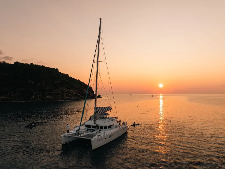 Coco Paradise, Yacht near the island at sunset